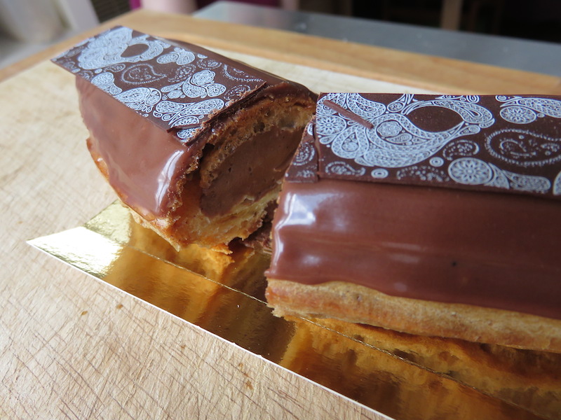 A fancy chocolate eclair cut in half